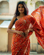 a woman in a red and white sari