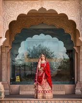 a woman in a red and gold bridal outfit
