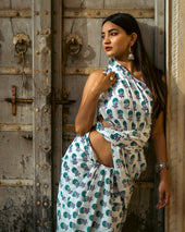 a woman in a dress leaning against a door