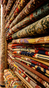 a large collection of rugs and carpets on display