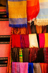 A colorful display of scarves and shawls in a store