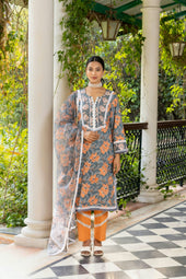 Woman poses in floral print, ethnic wear.