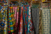 Colorful patterned fabrics hanging on display