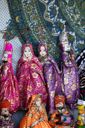 Colorful traditional indian puppets displayed on a patterned background