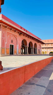 a pink building with arches and arches around it