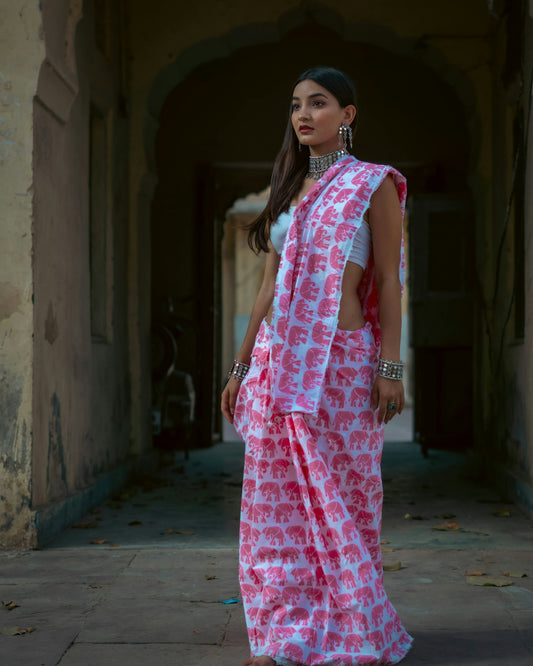 a woman in a pink and white sari