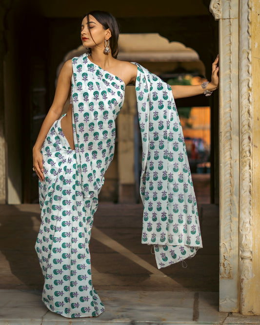 a woman in a white and green sari