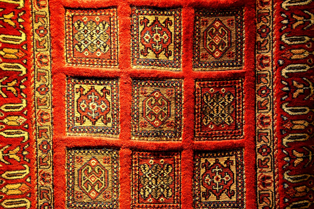 a red rug with designs