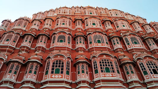 a tall red building with many windows and balconies