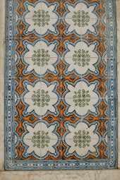 a close up of a tile design on a wall