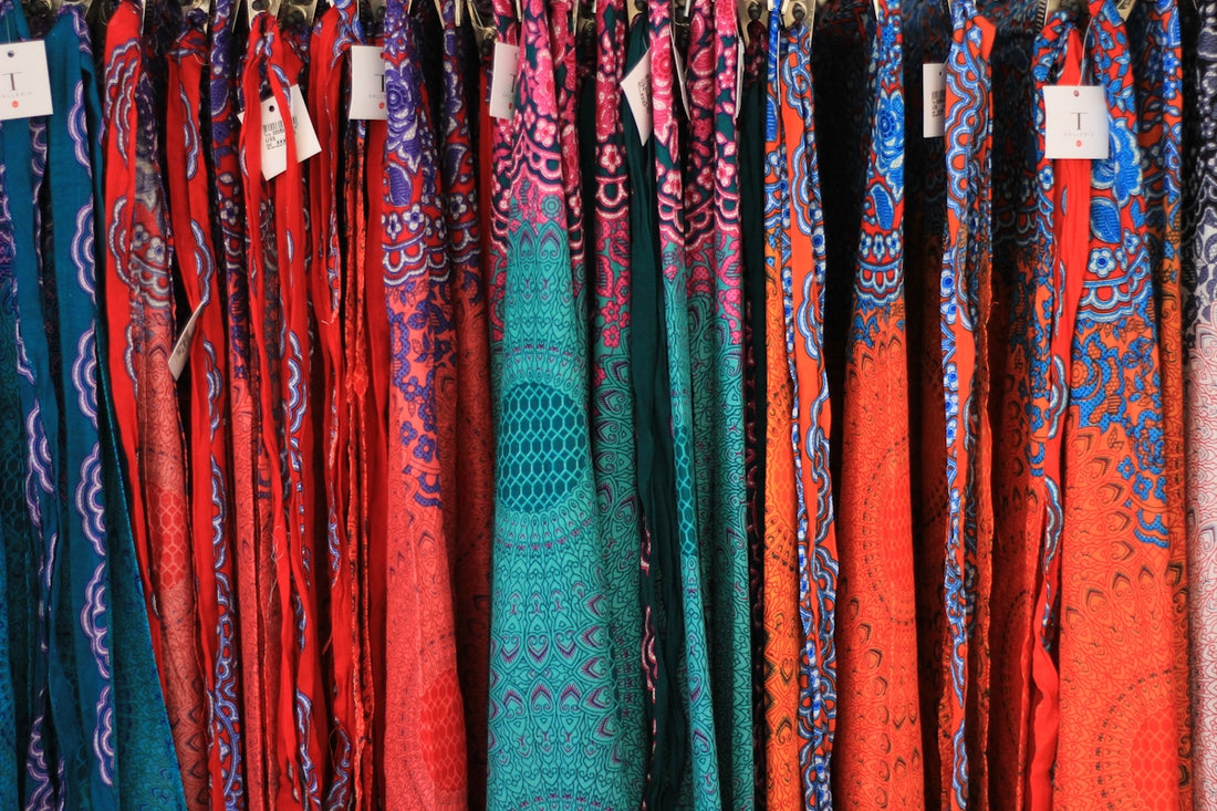 A rack of colorful scarves in a store