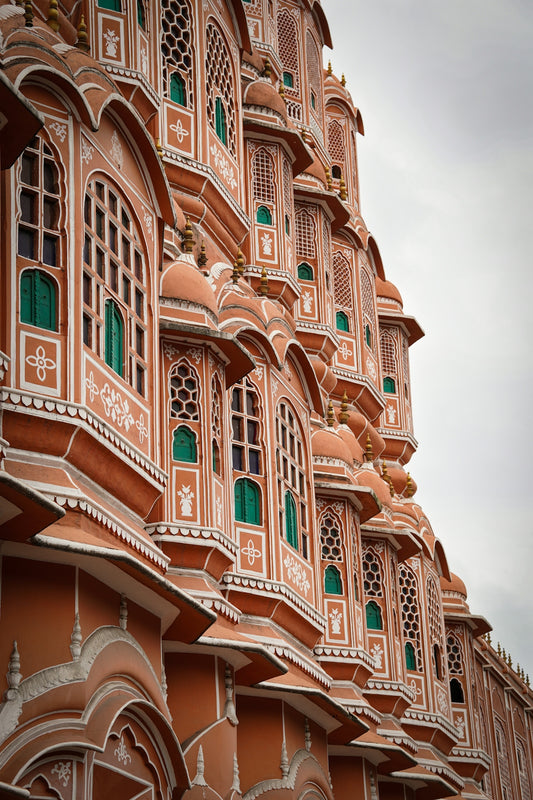 A tall building with many windows and green shutters