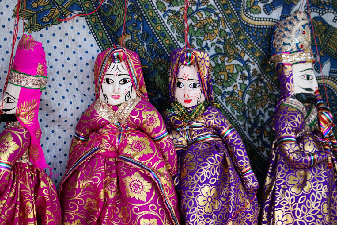 Four traditional indian puppets in ornate clothing