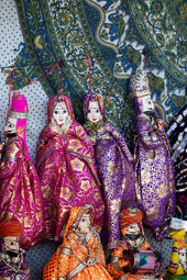 Colorful traditional indian puppets displayed on a patterned background