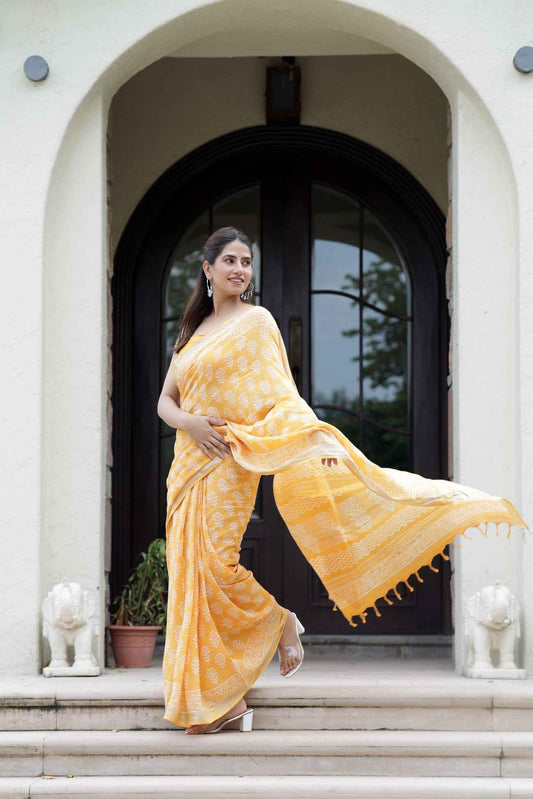 Srishti Textile Yellow Orange Floral Saree for Elegance Saree yellow-orange-floral-saree-posing-in-entrance